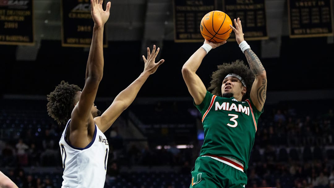 Jan 13, 2026; South Bend, Indiana, USA; Miami (FL) Hurricanes guard Tre Donaldson (3) shoots as Notre Dame Fighting Irish forward Jalen Haralson (10) defends during the second half at Purcell Pavilion at the Joyce Center. Mandatory Credit: Michael Caterina-Imagn Images