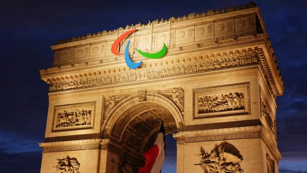 Arc de Triomphe decorated for the 2024 Summer Olympic Games with the Paris 2024 Olympic logo and French flag.