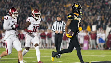 Nov 9, 2024; Columbia, Missouri, USA; Missouri Tigers wide receiver Theo Wease Jr. (1) scores a touchdown against Oklahoma Sooners defensive lineman Ethan Downs (40) and linebacker Kip Lewis (10) during the second half at Faurot Field at Memorial Stadium. Mandatory Credit: Jay Biggerstaff-Imagn Images