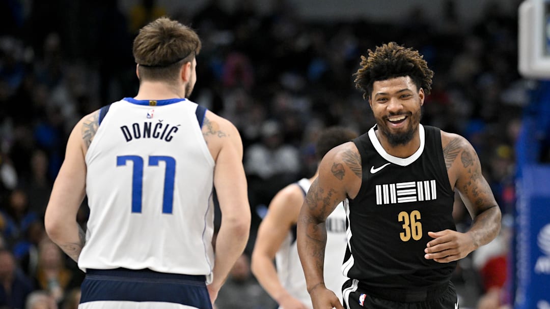 Jan 9, 2024; Dallas, Texas, USA; Memphis Grizzlies guard Marcus Smart (36) smiles after scoring against Dallas Mavericks guard Luka Doncic (77) during the first quarter at the American Airlines Center. Mandatory Credit: Jerome Miron-Imagn Images