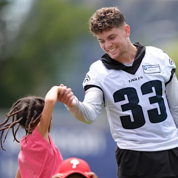 Jul 23, 2025; Philadelphia, PA, USA; Philadelphia Eagles defensive back Cooper DeJean (33) plays with the children of running back Saquon Barkley during training camp at NovaCare Complex. Mandatory Credit: Kyle Ross-Imagn Images