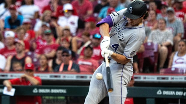 Colorado Rockies first baseman Michael Toglia swings a bat while wearing a gray uniform and black batting helmet.