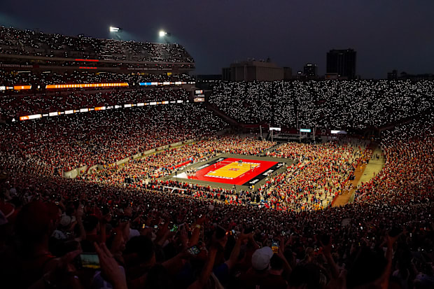 Fans hold up cell phone lights before the third set between the Nebraska Cornhuskers and the Omaha Mavericks at Memorial Stad