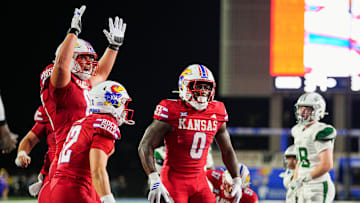 Kansas football players celebrate a touchdown by Harry Stewart III