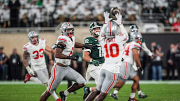Ohio State Buckeyes cornerback Denzel Burke intercepts a pass from Michigan State Spartans quarterback Aidan Chiles as tight end Jack Velling looks on during the third quarter at Spartan Stadium in East Lansing, Saturday, Sept. 28, 2024.