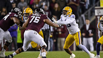 Nov 26, 2022; College Station, Texas, USA; Texas A&M Aggies offensive lineman Reuben Fatheree II (76) and LSU Tigers defensive end BJ Ojulari (18) in action during the game between the Texas A&M Aggies and the LSU Tigers at Kyle Field. Mandatory Credit: Jerome Miron-Imagn Images