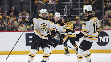 Apr 13, 2025; Pittsburgh, Pennsylvania, USA;  Boston Bruins center Jakub Lauko (94) celebrates his empty net goal with center Fraser Minten (93) and center Pavel Zacha (18)  against the Pittsburgh Penguins during the third period at PPG Paints Arena. Mandatory Credit: Charles LeClaire-Imagn Images