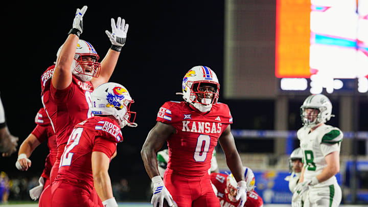 Kansas football players celebrate a touchdown by Harry Stewart III