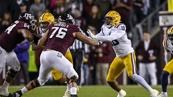 Nov 26, 2022; College Station, Texas, USA; Texas A&M Aggies offensive lineman Reuben Fatheree II (76) and LSU Tigers defensive end BJ Ojulari (18) in action during the game between the Texas A&M Aggies and the LSU Tigers at Kyle Field. Mandatory Credit: Jerome Miron-Imagn Images