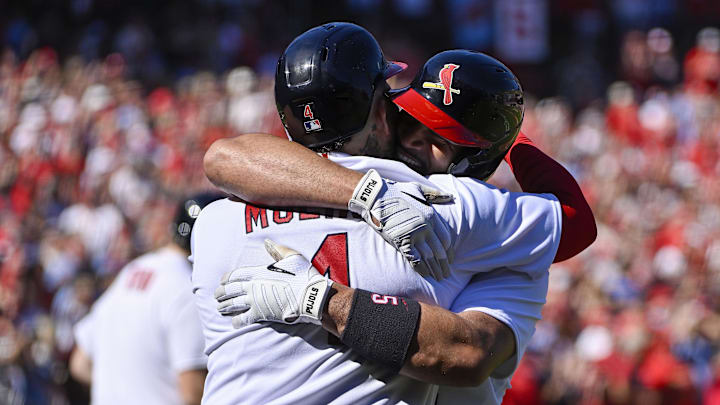 Oct 2, 2022; St. Louis, Missouri, USA;  St. Louis Cardinals first baseman Albert Pujols (5) celebrates with catcher Yadier Molina (4) after hitting a solo home run for his 702nd career home run during the third inning against the Pittsburgh Pirates at Busch Stadium. Mandatory Credit: Jeff Curry-Imagn Images