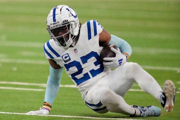 Indianapolis Colts cornerback Kenny Moore II (23) slides to the turf after intercepting a pass.