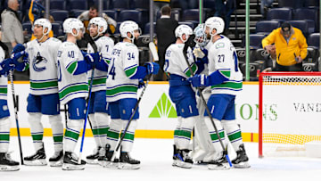 Jan 29, 2025; Nashville, Tennessee, USA;  Vancouver Canucks goaltender Thatcher Demko (35) celebrates the win with his teammates against the Nashville Predators during the third period at Bridgestone Arena. Mandatory Credit: Steve Roberts-Imagn Images