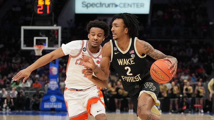 Mar 11, 2026; Charlotte, NC, USA; Wake Forest Demon Deacons forward Juke Harris (2) with the ball as Clemson Tigers guard Efrem Johnson (4) defends in the first half at Spectrum Center. Mandatory Credit: Bob Donnan-Imagn Images