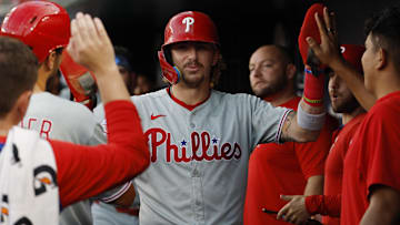 Aug 14, 2025; Washington, District of Columbia; Philadelphia Phillies second baseman Bryson Stott (5) celebrates with teammates in the dugout after scoring a run against the Washington Nationals during the third inning at Nationals Park. 