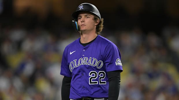 Colorado Rockies right fielder Mickey Moniak in a purple jersey and black batting helmet
