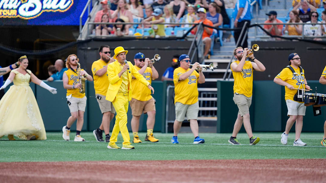 Jun 7, 2025; Charlotte, NC, USA; Team owner Jesse Cole leads the pep band out onto the field during the exhibition game between the Savannah Bananas and the Party Animals at Bank of America Stadium. Mandatory Credit: Jim Dedmon-Imagn Images