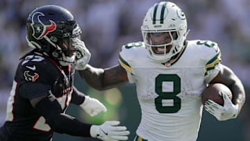 Green Bay Packers running back Josh Jacobs (8) stiff-arms Houston Texans safety Eric Murray (23) during the third quarter of their game Sunday, October 20, 2024 at Lambeau Field in Green Bay, Wisconsin.