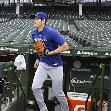 Apr 22, 2025; Chicago, Illinois, USA;  Los Angeles Dodgers two-way player Shohei Ohtani (17) enters the field for warmups before the game against the Chicago Cubs at Wrigley Field. Mandatory Credit: Matt Marton-Imagn Images
