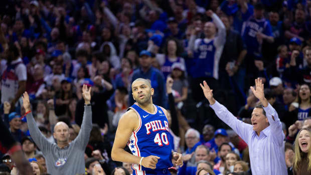 Apr 17, 2024; Philadelphia, Pennsylvania, USA; Fans react behind Philadelphia 76ers forward Nicolas Batum (40) after his three pointer against the Miami Heat during the third quarter of a play-in game of the 2024 NBA playoffs at Wells Fargo Center. Mandatory Credit: Bill Streicher-USA TODAY Sports