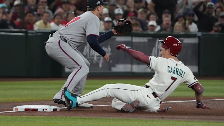 Corbin Carroll slides safely into third base for one of his two triples against the Braves on Sunday. Corbin Carroll slides safely into third base for one of his two triples against the Braves on Sunday.