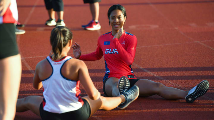 Regine Tugade trains with other athletes at the George Washington High School track in Mangilao.