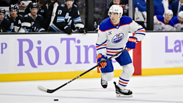 Nov 29, 2024; Salt Lake City, Utah, USA; Edmonton Oilers defenseman Evan Bouchard (2) moves the puck down the ice against the Utah Hockey Club during the third period at the Delta Center. Mandatory Credit: Christopher Creveling-Imagn Images