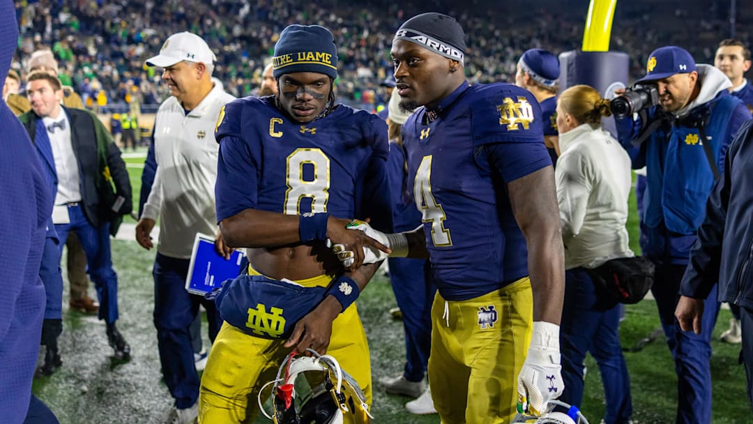 Nov 22, 2025; South Bend, Indiana, USA; Notre Dame Fighting Irish safety Adon Shuler (8) shakes hands with running back Jeremiyah Love (4) after beating the Syracuse Orange at Notre Dame Stadium. Mandatory Credit: Michael Caterina-Imagn Images