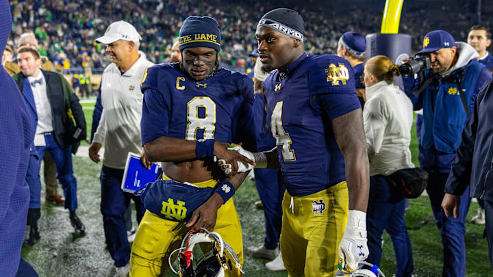 Nov 22, 2025; South Bend, Indiana, USA; Notre Dame Fighting Irish safety Adon Shuler (8) shakes hands with running back Jeremiyah Love (4) after beating the Syracuse Orange at Notre Dame Stadium. Mandatory Credit: Michael Caterina-Imagn Images