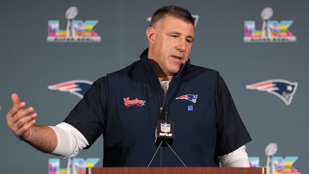 Mike Vrabel speaks from a podium at an unknown level of caffeination.