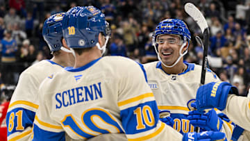 Feb 8, 2025; St. Louis, Missouri, USA;  St. Louis Blues right wing Mathieu Joseph (71) celebrates with center Dylan Holloway (81) and center Brayden Schenn (10) after scoring against the Chicago Blackhawks during the second period at Enterprise Center. Mandatory Credit: Jeff Curry-Imagn Images