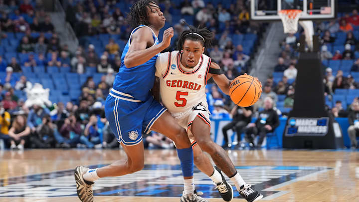 Mar 19, 2026; Buffalo, NY, USA; Georgia Bulldogs guard Jeremiah Wilkinson (5) dribbles the ball against Saint Louis Billikens guard Quentin Jones (1) during the second half of a first round game of the men's 2026 NCAA Tournament at Keybank Center. Mandatory Credit: Gregory Fisher-Imagn Images