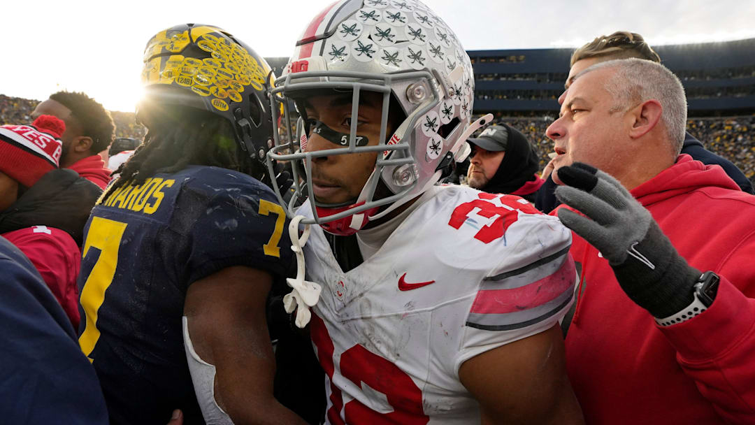 Ohio State Buckeyes running back TreVeyon Henderson (32) leaves the field after being greeted by University of Michigan running back Donovan Edward (7) following Saturday's NCAA Division I football game at Michigan Stadium in Ann Arbor.