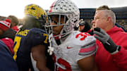 Ohio State Buckeyes running back TreVeyon Henderson (32) leaves the field after being greeted by University of Michigan running back Donovan Edward (7) following Saturday's NCAA Division I football game at Michigan Stadium in Ann Arbor.