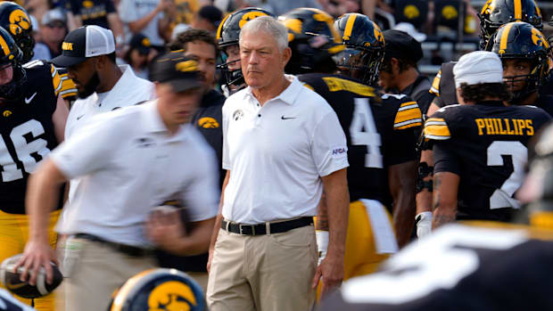 Iowa Hawkeyes head coach Kirk Ferentz watches his team warmup 