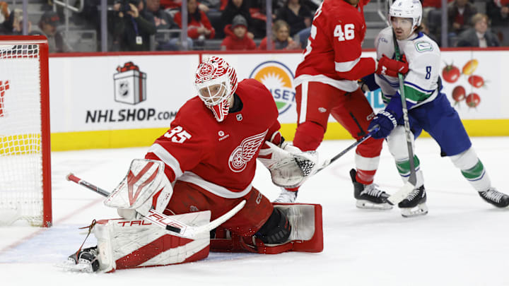 Dec 1, 2024; Detroit, Michigan, USA;  Detroit Red Wings goaltender Ville Husso (35) makes a save in the third period against the Vancouver Canucks at Little Caesars Arena. Mandatory Credit: Rick Osentoski-Imagn Images