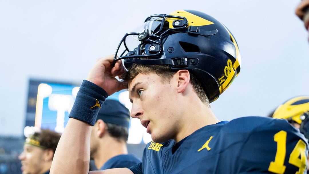Michigan Wolverines quarterback Tommy Carr (14) puts on his helmet as he waits to leave the field after defeating UTEP 52-17 at Michigan Stadium in Ann Arbor on Saturday, Sept. 19, 2026.