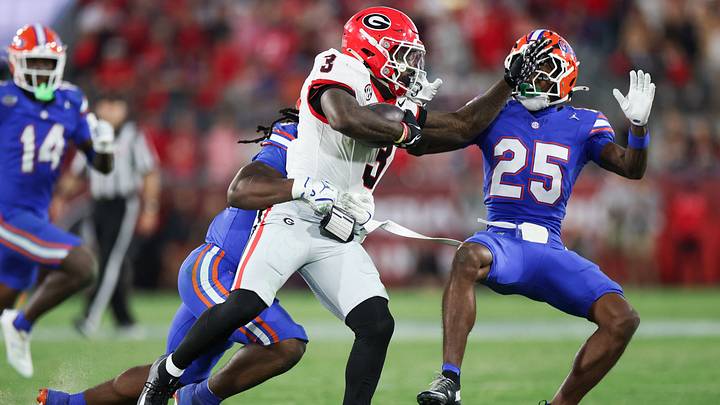 Nov 1, 2025; Jacksonville, Florida, USA; Georgia Bulldogs running back Nate Frazier (3) runs with the ball while stiff arming Florida Gators defensive back Cormani McClain (25) in the second half at EverBank Stadium. Mandatory Credit: Matt Pendleton-Imagn Images