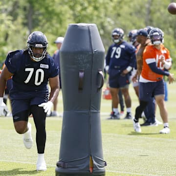 Braxton Jones runs to block a dummy on a screen pass drill last year. Until he's able to do this now, the tackle battle is wide open.