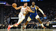Nov 4, 2025; San Francisco, California, USA; Phoenix Suns guard Devin Booker (1) drives to the basket against Golden State Warriors forward Jonathan Kuminga (1) in the second quarter at Chase Center. Mandatory Credit: Eakin Howard-Imagn Images