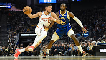 Nov 4, 2025; San Francisco, California, USA; Phoenix Suns guard Devin Booker (1) drives to the basket against Golden State Warriors forward Jonathan Kuminga (1) in the second quarter at Chase Center. Mandatory Credit: Eakin Howard-Imagn Images