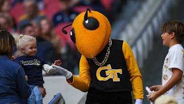 Oct 19, 2024; Atlanta, Georgia, USA; Georgia Tech Yellow Jackets mascot Buzz interacts with a fan against the Notre Dame Fighting Irish in the second quarter at Mercedes-Benz Stadium. Mandatory Credit: Brett Davis-Imagn Images