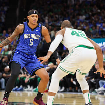 Apr 27, 2025; Orlando, Florida, USA; Orlando Magic forward Paolo Banchero (5) controls the ball from Boston Celtics center Al Horford (42) in the first quarter during game four of first round for the 2025 NBA Playoffs at Kia Center. Mandatory Credit: Nathan Ray Seebeck-Imagn Images