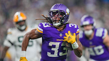 Dec 29, 2024; Minneapolis, Minnesota, USA; Minnesota Vikings running back Aaron Jones (33) runs with the ball against Green Bay Packers in the third quarter at U.S. Bank Stadium. Mandatory Credit: Brad Rempel-Imagn Images