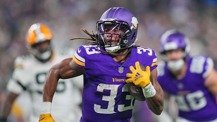 Dec 29, 2024; Minneapolis, Minnesota, USA; Minnesota Vikings running back Aaron Jones (33) runs with the ball against Green Bay Packers in the third quarter at U.S. Bank Stadium. Mandatory Credit: Brad Rempel-Imagn Images
