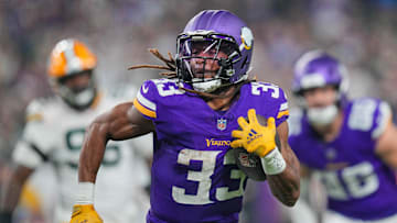 Dec 29, 2024; Minneapolis, Minnesota, USA; Minnesota Vikings running back Aaron Jones (33) runs with the ball against Green Bay Packers in the third quarter at U.S. Bank Stadium. Mandatory Credit: Brad Rempel-Imagn Images