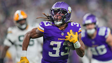 Dec 29, 2024; Minneapolis, Minnesota, USA; Minnesota Vikings running back Aaron Jones (33) runs with the ball against Green Bay Packers in the third quarter at U.S. Bank Stadium. Mandatory Credit: Brad Rempel-Imagn Images