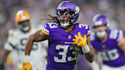 Dec 29, 2024; Minneapolis, Minnesota, USA; Minnesota Vikings running back Aaron Jones (33) runs with the ball against Green Bay Packers in the third quarter at U.S. Bank Stadium. 