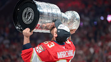 Jun 17, 2025; Sunrise, Florida, USA; Florida Panthers center Brad Marchand (63) hoists the Stanley Cup after winning game six of the 2025 Stanley Cup Final against the Edmonton Oilers at Amerant Bank Arena. Mandatory Credit: Sam Navarro-Imagn Images