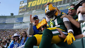 Green Bay Packers wide receiver Jayden Reed (11) celebrates with fans after scoring a touchdown against the Detroit Lions during the second quarter at Lambeau Field.
