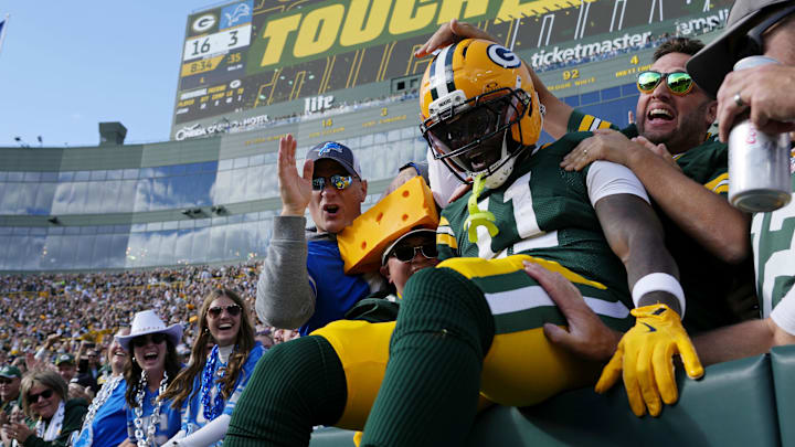 Green Bay Packers wide receiver Jayden Reed (11) celebrates with fans after scoring a touchdown against the Detroit Lions during the second quarter at Lambeau Field.